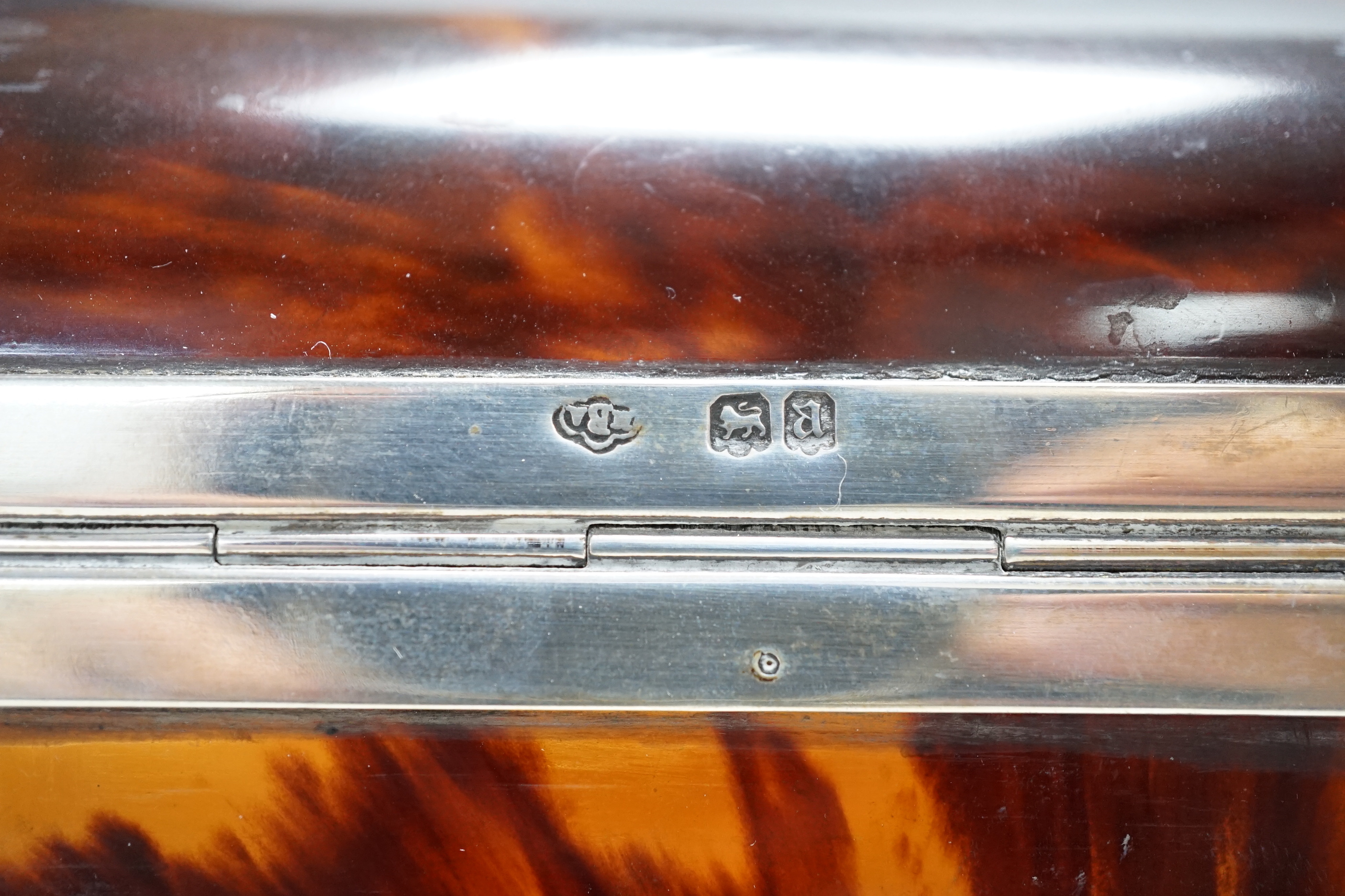 A George V silver mounted tortoiseshell domed top jewellery casket (a.f.) J.Batson & Sons, London, 1916, retailed by Asprey, London, 19.6cm, together with a small Edwardian silver mounted tortoiseshell photograph frame.